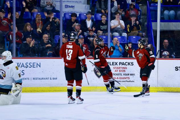 Vancouver Giants exchange congratulations after a goal against the Portland Winterhawks