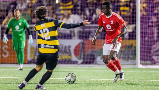 Pittsburgh Riverhounds SC's Charles Ahl and Phoenix Rising's Ascel Essengue on game night