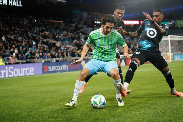 Sounders FC attemtpt to keep Minnesota United FC from the ball