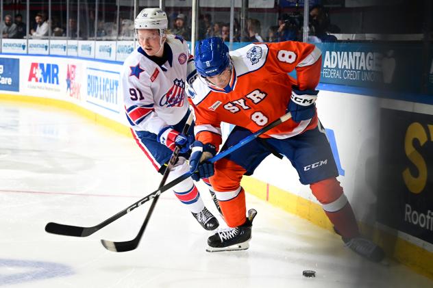 Syracuse Crunch defenseman Tommy Miller (right) vs. the Rochester Americans