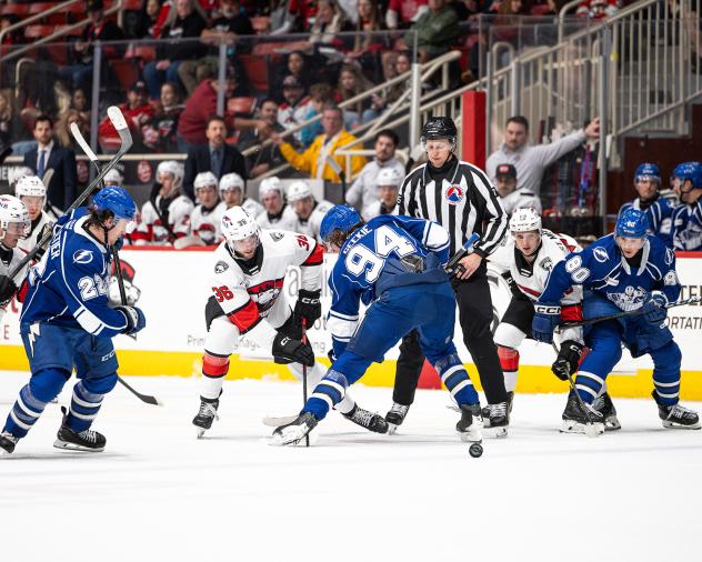 Syracuse Crunch center Conor Geekie (center) vs. the Charlotte Checkers