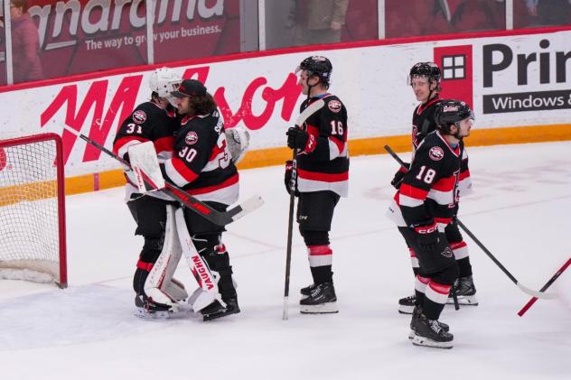 Belleville Senators exchange congratulations following a win