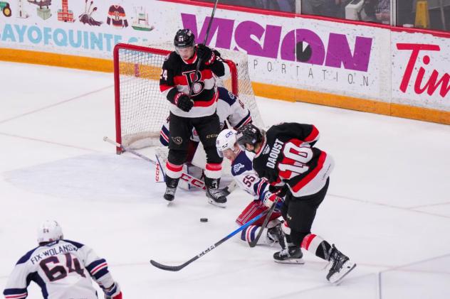 Belleville Senators centre Philippe Daoust shoots while Jan Jeník screens the goaltender