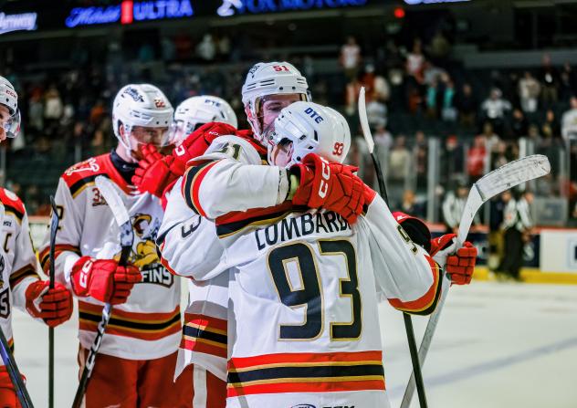 Grand Rapids Griffins congratulate Amadeus Lombardi after his overtime winner
