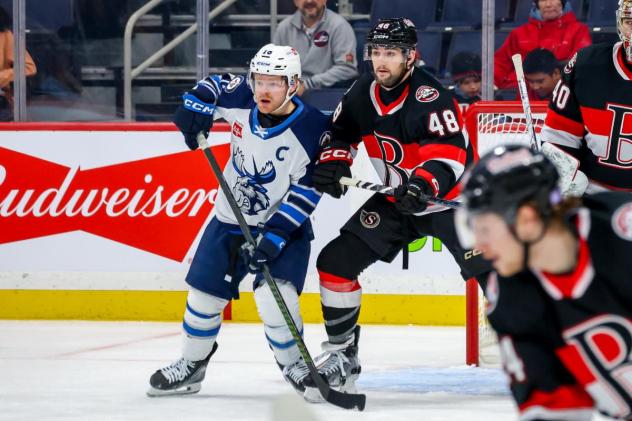 Belleville Senators defenceman Dennis Gilbert (right) vs. the Manitoba Moose