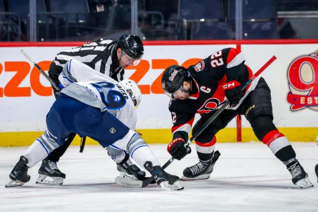 Belleville Senators centre Garrett Pilon (right) faces off with the Manitoba Moose