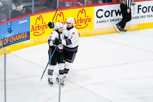 Kelowna Rockets exchange congratulations following a goal