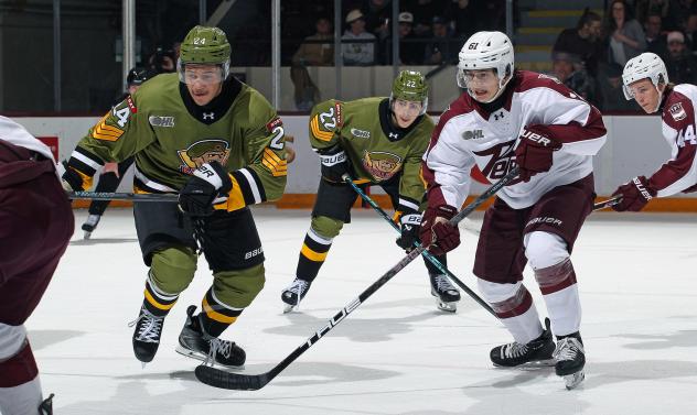 Peterborough Petes centre Kaden McGregor (right) vs. the North Bay Battalion
