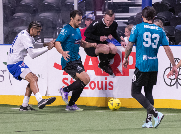 An official hops out of the way as the St. Louis Ambush battle the Kansas City Comets