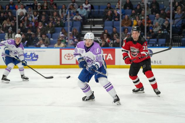 Syracuse Crunch's Nick Abruzzese and Utica Comets' Topias Vilén on the ice