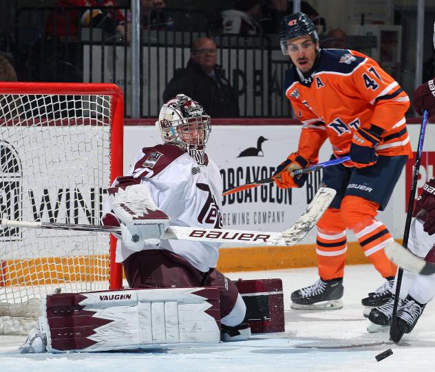 Peterborough Petes goaltender Easton Rye tips aside a Flint Firebirds' shot