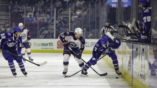Syracuse Crunch defenseman Simon Lundmark (far right) vs. the Cleveland Monsters