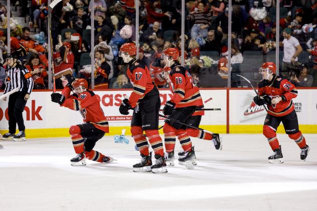 Ethan Moore of the Calgary Hitmen celebrates scoring his teddy bear goal