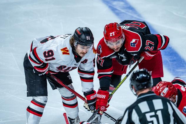 Rapid City Rush forward Blake Bennett (left) faces off with the Allen Americans