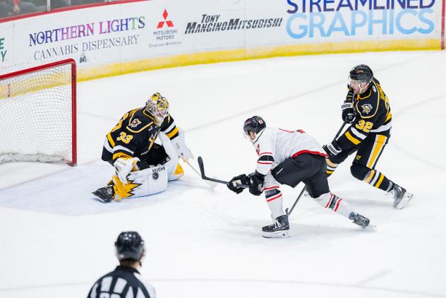 Wheeling Nailers goaltender Taylor Gauthier tips aside an Adirondack Thunder shot