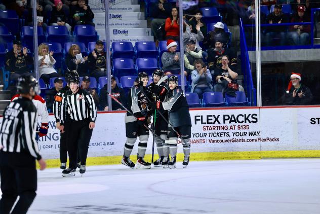 Vancouver Giants exchange congratulations after a goal vs. the Spokane Chiefs