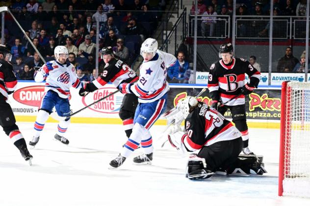 Rochester Americans' Tyler Kopff battles Belleville Senators' Oskar Pettersson and Hunter Shepard