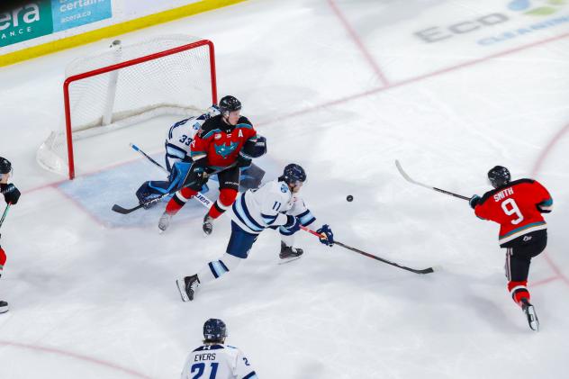 Kelowna Rockets centre Shane Smith (right) takes a shot against the Penticton Vees