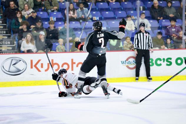 Vancouver Giants defenceman Colton Alain flattens a member of the Calgary Hitmen