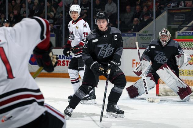 Peterborough Petes defenceman Carson Cameron sets up in front of goaltender Easton Rye