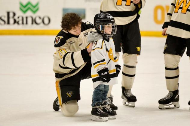 Wheeling Nailers help a young fan on skates