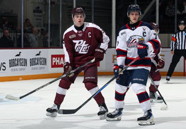 Peterborough Petes defenceman Carson Cameron (left) vs. the Saginaw Spirit