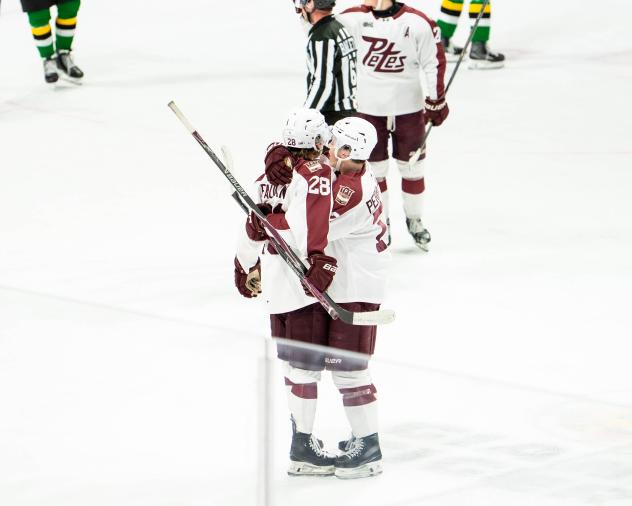 Peterborough Petes defenceman Matthew Perreault (right) congratulates Brennan Faulkner