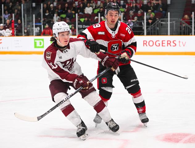 Peterborough Petes centre Adam Levac (left) vs. the Ottawa 67's
