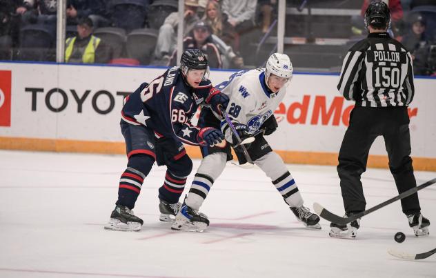 Wenatchee Wild's Caelan Joudrey and Tri-City American's Gavin Garland in action