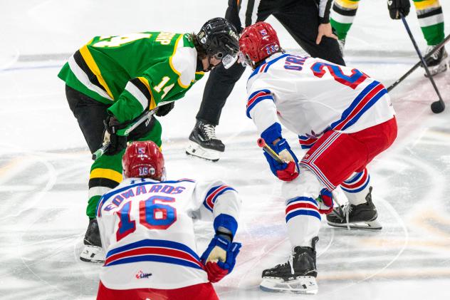 Sam O'Reilly of the Kitchener Rangers (right) faces off with the London Knights