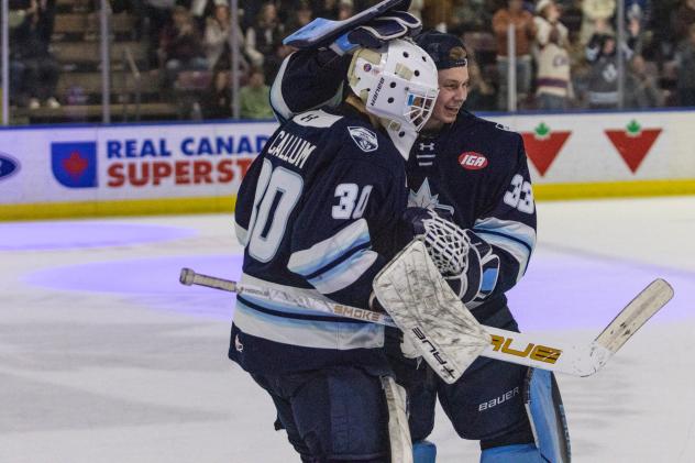 Penticton Vees goaltender Ethan McCallum is congratulated by Andrew Reyelts