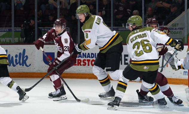 Peterborough Petes left wing Brennan Faulkner (left) vs. the North Bay Battalion