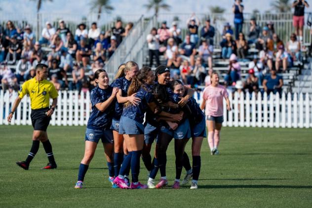 Seattle Reign FC mobs Nerilia Mondesir after her goal against Angel City FC