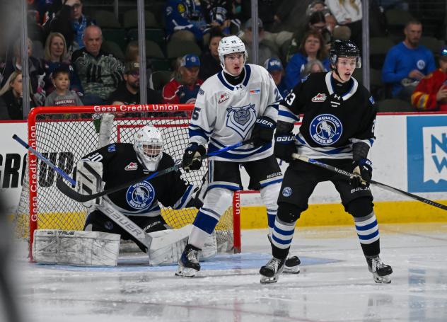 Wenatchee Wild's Cal Conway and Sam Elliott and Victoria Royals' Reggie Newman on game night