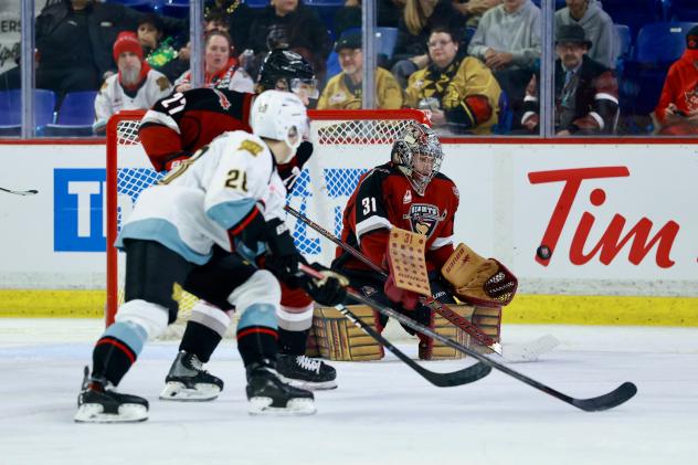 Vancouver Giants' Ethan Mittelsteadt and Kelton Pyne battle Portland Winterhawks' Nathan Brown