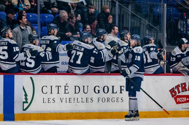 Worcester Railers high five forward Riley Piercey along the bench
