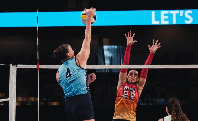 Grand Rapids Rise setter Camryn Turner (right) goes high for a block against the Orlando Valkyries