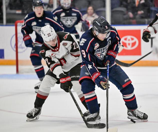 Vancouver Giants right wing Joe Iginla (left) fights for the puck vs. the Tri-City Americans
