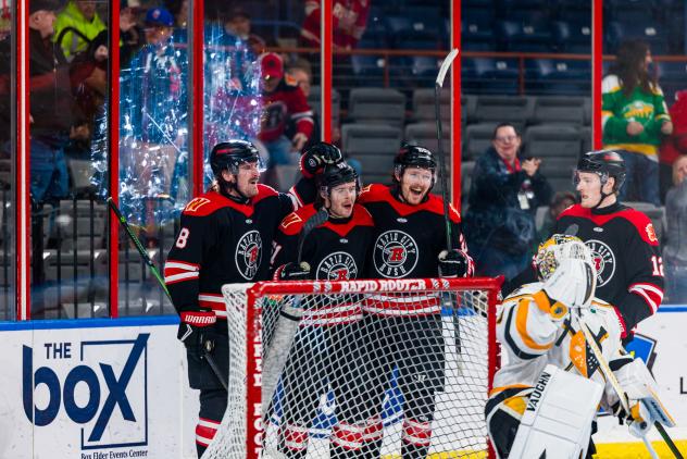 Rapid City Rush gather following a goal