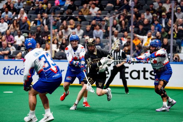 Vancouver Warriors' Curtis Dickson battles Toronto Rock's Josh Jubenville, Rocbert Hudson, and Challen Rogers