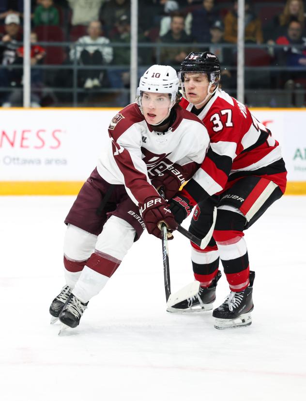 Peterborough Petes centre Adam Levac (left) vs. the Ottawa 67's