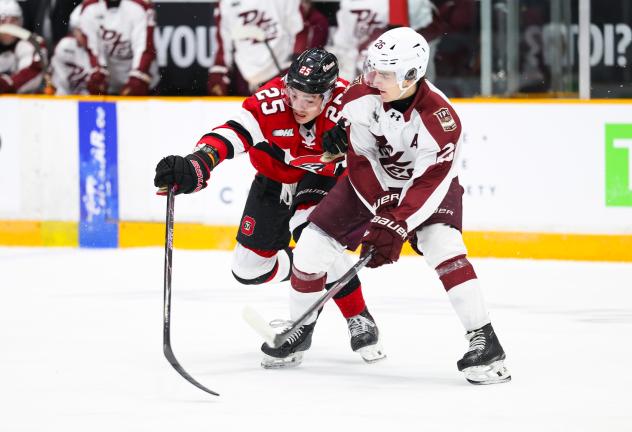 Peterborough Petes centre Aidan Young (right) vs. the Ottawa 67's