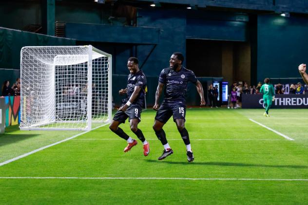 Oakland Roots' Peter Wilson and Neveal Hackshaw on the field