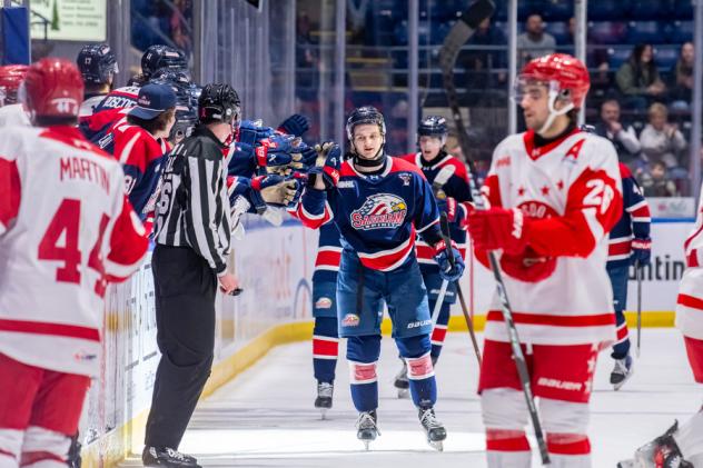 Saginaw Spirit exchange fist bumps along the bench