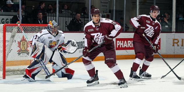 Peterborough Petes right wing Matthew Soto (center) and centre Aiden Young vs. the Barrie Colts