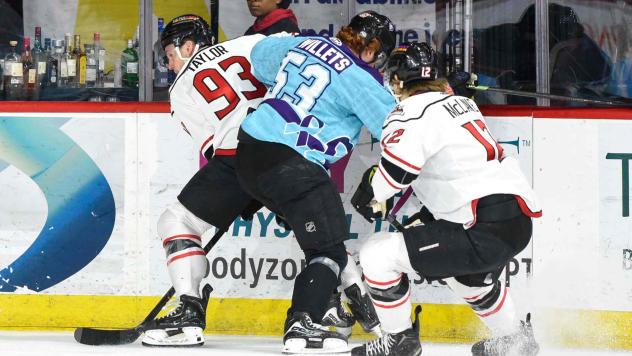 Adirondack Thunder forwards Justin Taylor (left) and Chase McLane fight for the puck vs. the Reading Royals