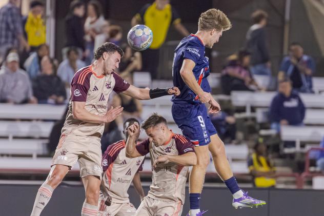 Detroit City FC goes high for a ball at Indy Eleven