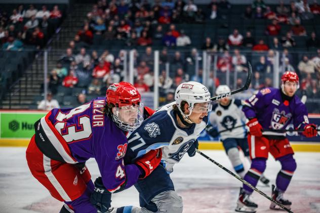 Grand Rapids Griffins right wing Carter Mazur tries to hold off the Milwaukee Admirals