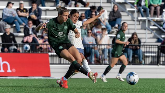 Racing Louisville FC and Seattle Reign FC in action