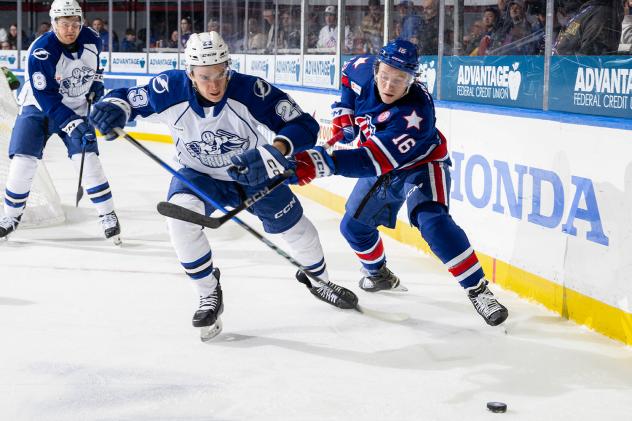 Syracuse Crunch defenseman Maxim Groshev (left) vs. the Rochester Americans